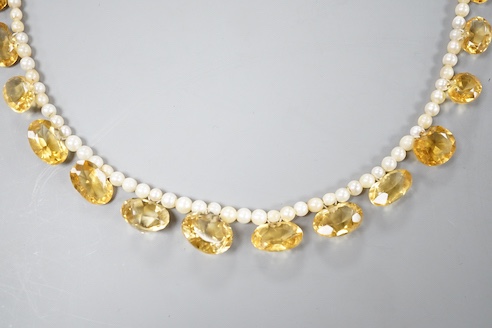 A single strand oval cut citrine and seed pearl set fringe necklace, with 9ct clasp, 44cm
